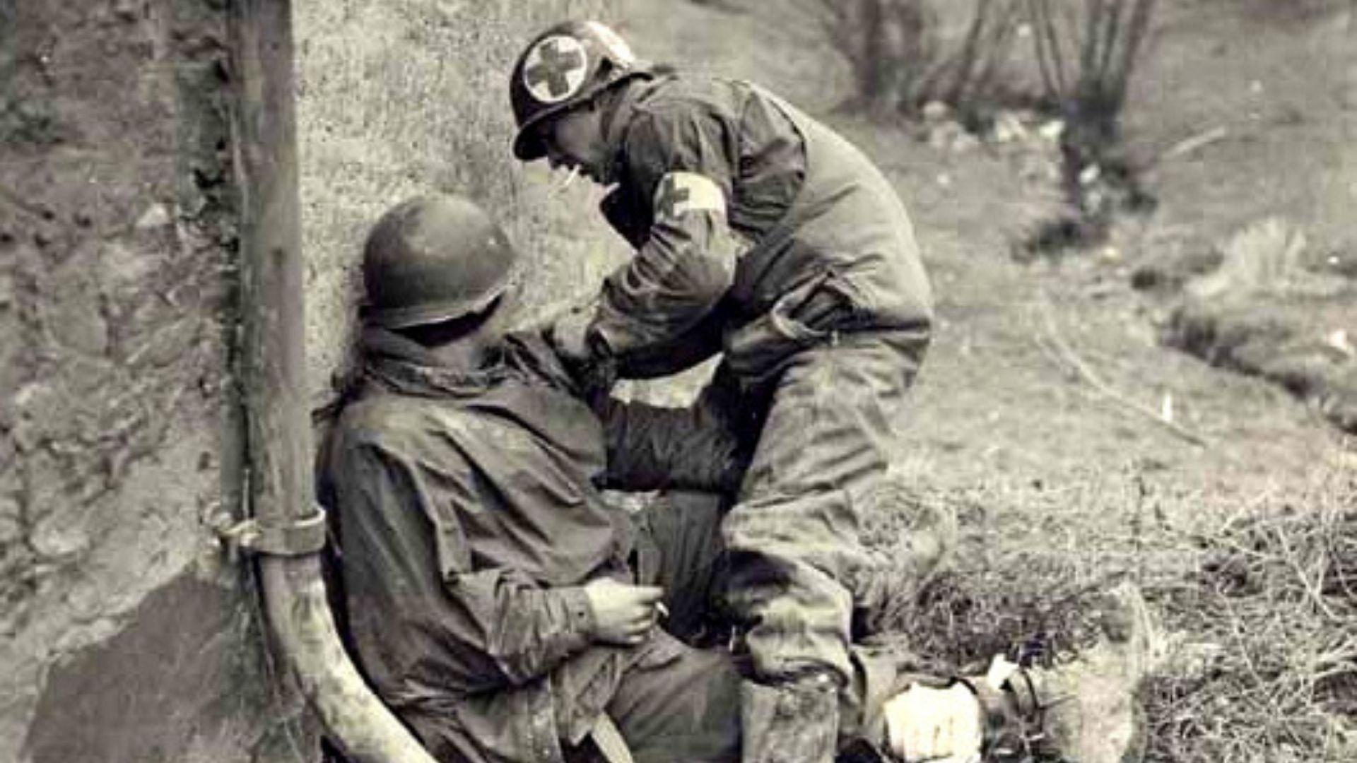 Two American Airborne medics care for both American and German wounded on D-Day